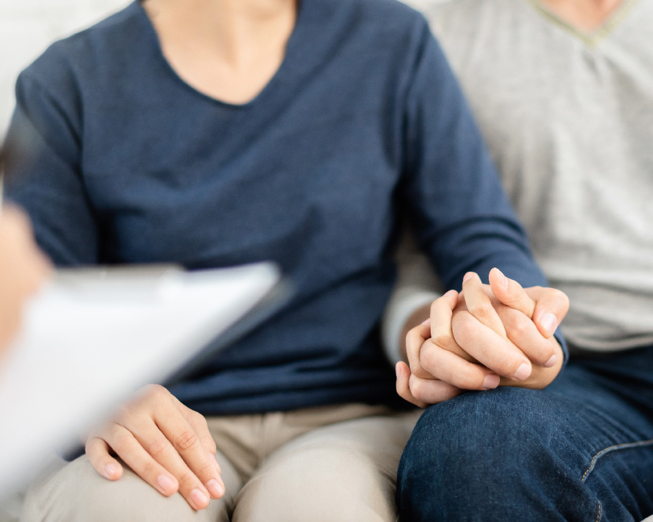 Couple sitting on a couch doing estate planning in San Antonio